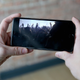 Image for article titled Friends Excitedly Gather Around Man’s Phone To Watch Shaky Footage Of Concert